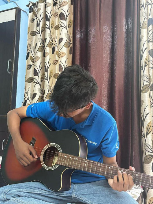 Alumnos practicando con su guitarra